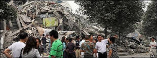 Parents wait anxiously outside the flattened Juyuan Middle School. Photo: AFP