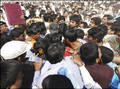 Job candidates tussle for enrollment forms at a career fair in India, where more than half a million jobs vanished in the last three months of 2008, according to the World Bank. Photo: Mahesh Kumar/Associated Press