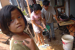 Transferring drinking water from one pail to the next. People must pay the equivalent of up to $1 daily to buy clean water for drinking and cooking from vendors transporting water in jugs.Photo: Jefri Aries/IRIN