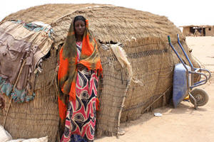 Maria Farah outside her ari.  Every day, 500g of boiled wheat is divided up between two adults, four children, a calf, a goat and a donkey in the Farah household. It is the only food they have had after rains failed for the past two seasons. The 15kg sack of wheat is provided to about 1,200 people in the Bisle area, which has four settlements, under the government-run Productive Safety Net Programme (PSNP) as payment for work, such as digging water holes. "It is boiled wheat for breakfast and for the main meal � we don't have anything else � no milk, no meat, no vegetables, no oil," says Maria Farah, the mother. Not surprisingly, two of her children are severely malnourished.  Photo: Jaspreet Kindra/IRIN &nbsp;