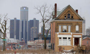 A single home in a block once filled with houses with the Detroit headquarters of General Motors in the distance. The company is thriving again. J.D. Pooley/Getty Images 