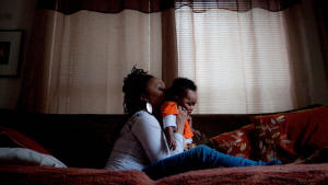 Photo of mother with child. A time to fight: Faced with the foreclosure of her home, Detroit resident LaKeisha Tuggle devised creative solutions to weather economic hardship. Photo: New York Times