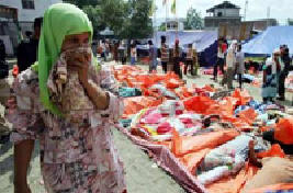 Woman searches for her child after tidal wave that hit Aceh, Indonesia