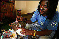 Faruk Maunge, 36, a high school counselor in Francistown, Botswana, points out one of several friends who died of complications from AIDS. Photo: �Craig Timberg /Washington Post)