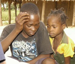 Custodio Julio, 16, and his sister Edita, 5. Every day is a scramble for food Photo: &nbsp;�Alfredo Mueche/IRIN