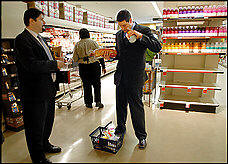 Rep. Tim Ryan (D-Ohio), right, deliberates with press secretary Brad Bauman about which items to keep in his basket as he buys $21 worth of groceries, the weekly food stamp allotment, as part of a House Hunger Caucus challenge. Photo: Katherine Frey/The Washington Post