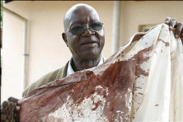 Felix Muzambi, 64, a taxidermist and grandfather, displays a bloodstained shirt he wore on the day he was beaten by a gang of ruling party youths. Photo: Washington Post