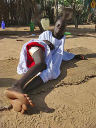 �I thought I was dead,� said Nasser Mahmoud Mohammed, 8, who was shot in the leg last month when he sneaked out of his parents� hut during a standoff with government troops at the Kalma camp. Troops killed 31 people, including 17 women and children, and injured at least 65. Photo: Edmund Sanders/Los Angeles Times