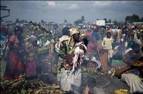 Congolese gather at an improvised displaced persons camp in Kibati, 15 miles north of the provincial capital of Goma, near where fighting was centered. Other refugees fled to Uganda. Photo: Walter Astrada/Getty Images