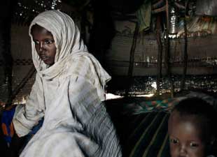The global food crisis has arrived at Safia Ali�s hut. She cannot afford rice or wheat or powdered milk anymore. At the same time, a drought has decimated her family�s herd of goats, turning their sole livelihood into a pile of bleached bones and papery skin. The result is that Ms. Safia, a 25-year-old mother of five, has not eaten in a week. Her 1-year-old son is starving too, an adorable, listless boy who doesn�t even respond to a pinch. Photo: Jehad Nga/New York Times