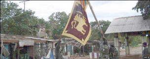 Sri Lankan troops raise the flag in newly retaken village. Photo: AFP