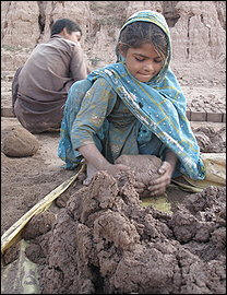 Many kiln workers are children, like 6-year-old Samia, who molds clay into balls for bricks. Photo: Pamela Constable Washington Post 