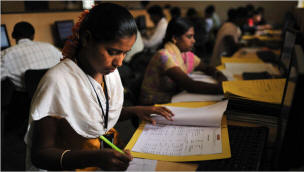 Lakshmi H.S., 19, checked medical records at a Rural Shores outsourcing center in the Indian village of Bagepalli, where she has worked for the last six months. Photo: Lynsey Addario/New York Times