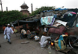 Help coming? An Indian family cooks on a New Delhi street. The country is launching an ambitious bid to improve delivery of food subsidies by issuing a national identity card. Photo: Newscom