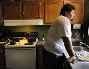 After losing their jobs, Scott and Kelly Nichols watched their finances and options dwindle, eventually making the tough decision to move their family to Kelly's mother's basement in Michigan. Photo: Washington Post  See article for further pictures