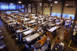 Inmates squeeze into rows of bunk beds at San Quentin. Federal judges have said California prisons are so crowded that they constitute cruel and unusual punishment. Photo: Eric Risberg/Associated Press