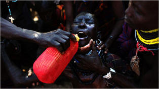 An elderly woman is given water in the Turkana region of Kenya. Many of the elderly are too weak and sick to feed themselves or drink. Photo: Jehad Nga/New York Times 