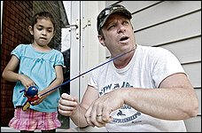 Dwight Michael Frazee, who has been out of steady work for two years, and his daughter, Jenna, 5, go fishing near their home in Toms River, N.J. Photo: Mike Mclaughlin/Washington Post) 