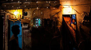 People at night in Dharavi. As many as a million people live and work in Dharavi, a sprawling slum in Mumbai, India. Photo: Adam Ferguson/New York Times