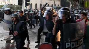 Riot police officers rushed to confront protesters on Tuesday in Cairo. Photo: Scott Nelson/New York Times