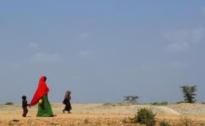 Photo: woman and children walking in African desert. Challenges of a changing climate: Rich nations bear historic responsibility for putting carbon dioxide into the air, but are they doing enough to help poor countries steel themselves against emissions’ effects? Photo: Washington Post