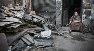 Photo of poor woman sitting next to collapsed building.. In Boulaq, so long neglected that houses regularly collapse, there had been little expectation that leaders would provide. But the disregard of the new president has been harder to take. Photo:Tara Todras-Whitehill/New York Times
