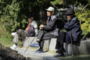 Elderly men sit on benches at Tapgol Park in the Jongro-gu area of Seoul. South Korea has risen from the economic ashes, but its old are increasingly poor. Photo: Woohae Cho/Bloomberg