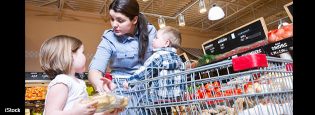 Woman grocery shopping with her two children.