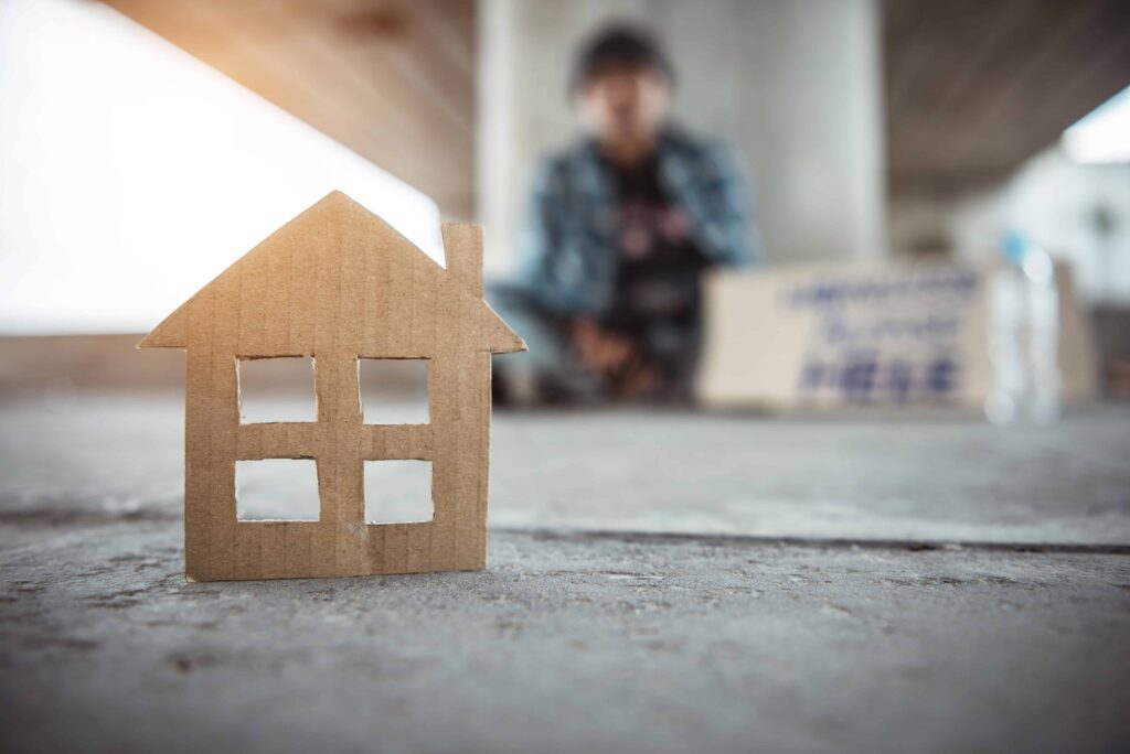 paper cut out of house with blurred out child in background